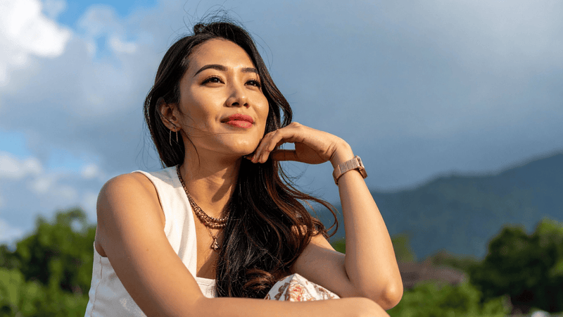 Woman relaxing outdoors with mountain backdrop